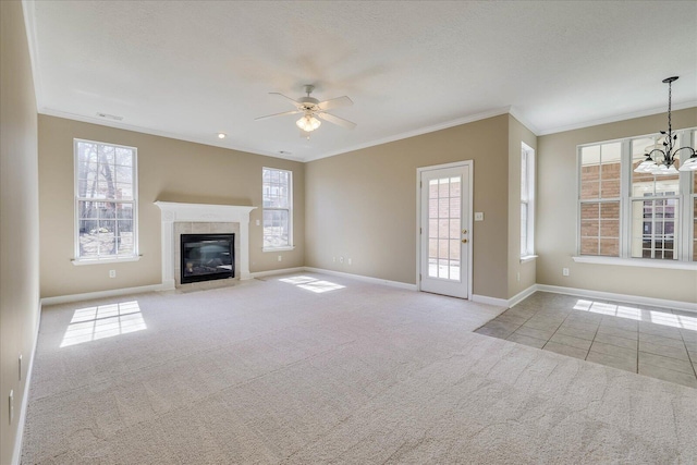 unfurnished living room featuring a healthy amount of sunlight, light colored carpet, and crown molding