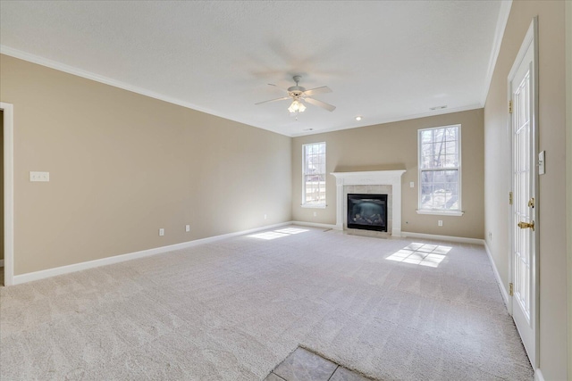 unfurnished living room with a fireplace with flush hearth, light carpet, crown molding, and baseboards