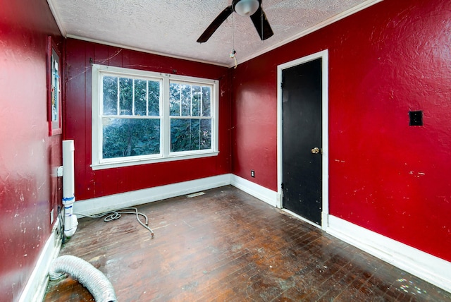 unfurnished room with a textured ceiling, dark wood-type flooring, ceiling fan, and ornamental molding