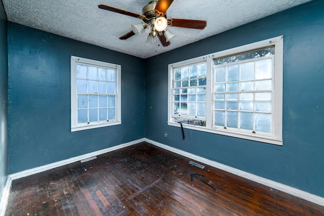 unfurnished room with ceiling fan, wood-type flooring, and a textured ceiling