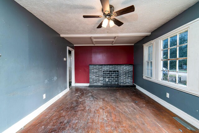 empty room with a textured ceiling and ceiling fan