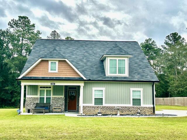 craftsman-style home with a porch and a front yard