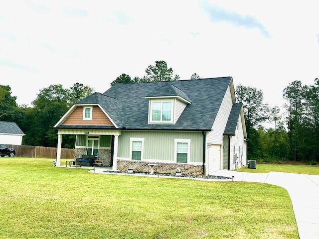 view of front facade with a front lawn, a porch, and a garage