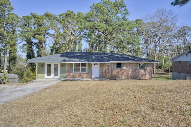 ranch-style home with brick siding, a front lawn, and french doors