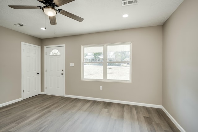 entryway featuring visible vents, light wood-style flooring, and baseboards