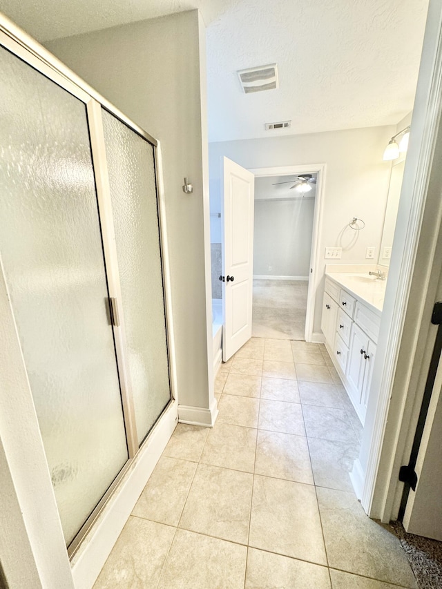 1026 Barrett Dr, Evans, GA 30809 - bathroom with vanity, a stall shower, a garden tub, tile patterned flooring, and a textured ceiling