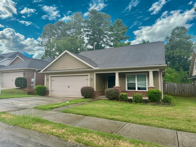 1026 Barrett Dr, Evans, GA 30809 - view of front facade with brick siding, concrete driveway, a garage, covered porch, and roof with shingles