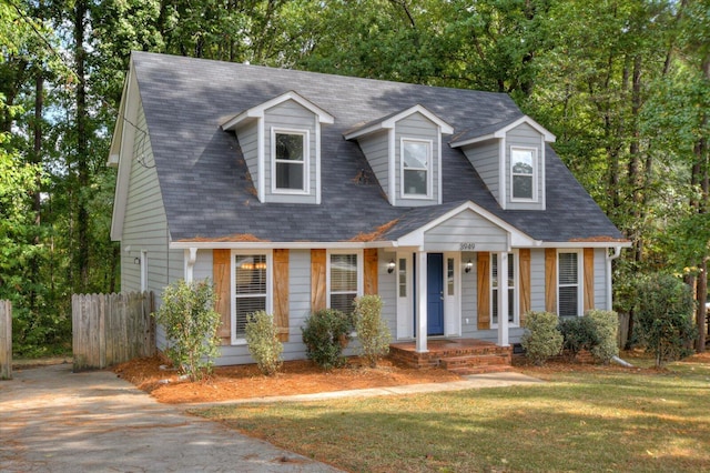 cape cod house with a front lawn