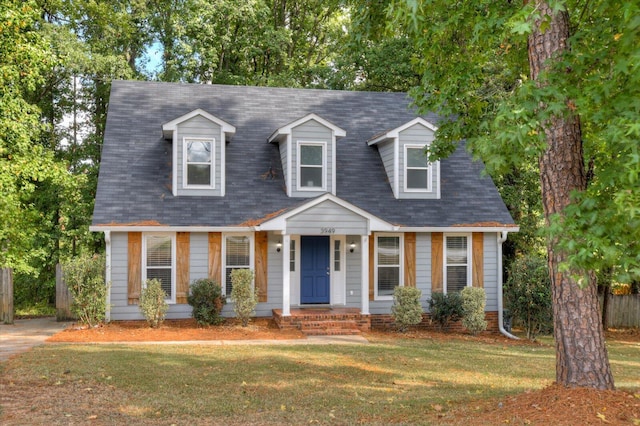 cape cod home with a front yard