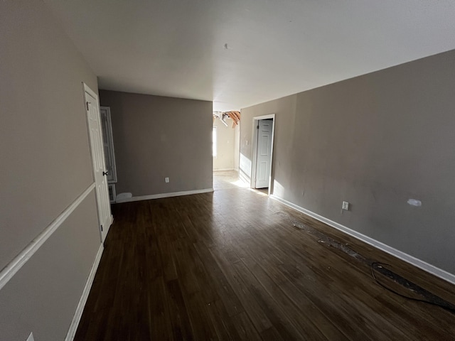 unfurnished room featuring dark wood-type flooring