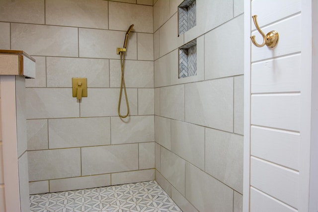 bathroom with a tile shower