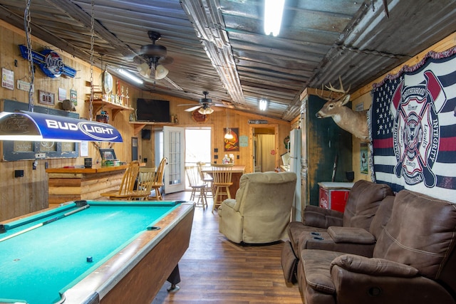 recreation room featuring ceiling fan, wood walls, hardwood / wood-style floors, lofted ceiling, and pool table