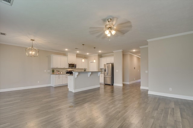 3109 Lobella Dr, Grovetown, GA 30813 - unfurnished living room featuring a ceiling fan, ornamental molding, baseboards, dark wood finished floors, and a chandelier