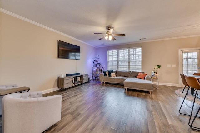 living room featuring crown molding, wood-type flooring, and ceiling fan