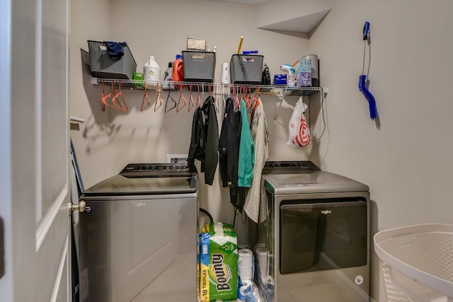 clothes washing area with washing machine and dryer