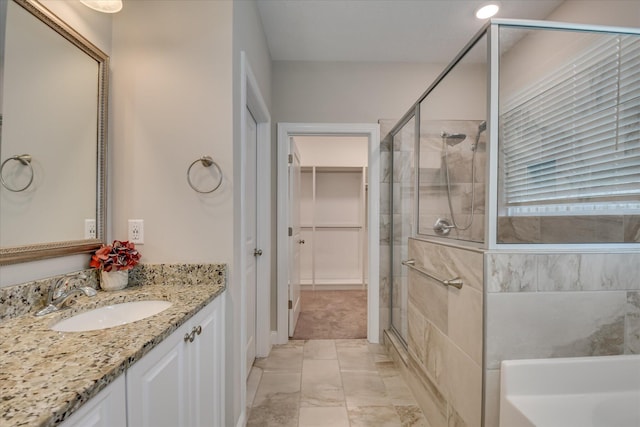 3109 Lobella Dr, Grovetown, GA 30813 - bathroom with a shower stall, vanity, marble finish flooring, a spacious closet, and a bath