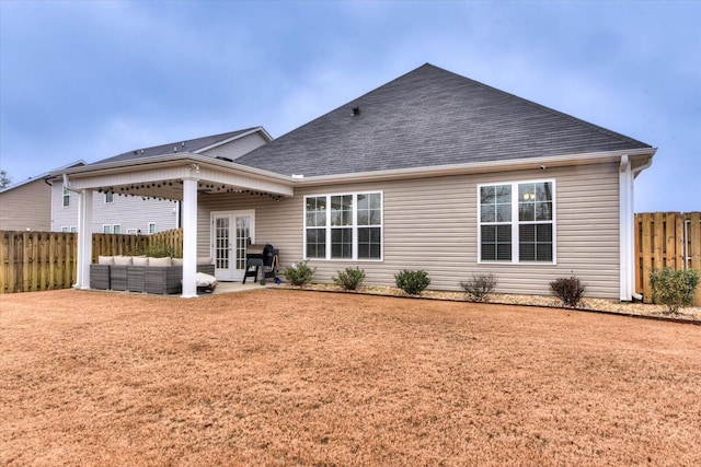 rear view of house with french doors, a yard, outdoor lounge area, and a patio