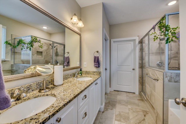 bathroom featuring vanity and a shower with door