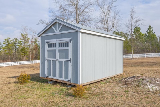 view of outbuilding featuring a lawn