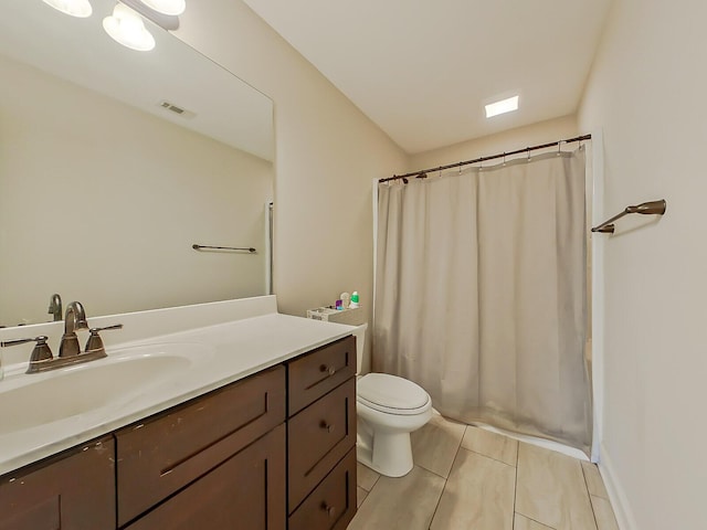 bathroom featuring vanity, toilet, and curtained shower