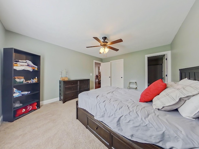 bedroom featuring light carpet and ceiling fan