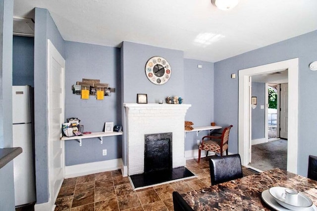 209 Ellis St, Augusta, GA 30901 - dining room with baseboards and a brick fireplace