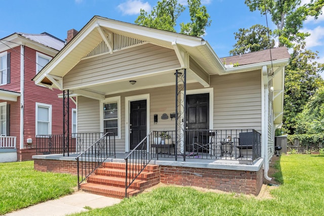 209 Ellis St, Augusta, GA 30901 - shotgun-style home with a front yard, a porch, and a chimney