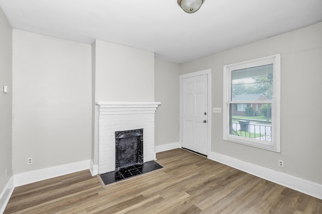 209 Ellis St, Augusta, GA 30901 - unfurnished living room featuring wood finished floors and a fireplace