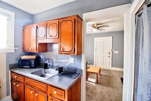 209 Ellis St, Augusta, GA 30901 - kitchen featuring light countertops, a ceiling fan, black microwave, carpet, and brown cabinets