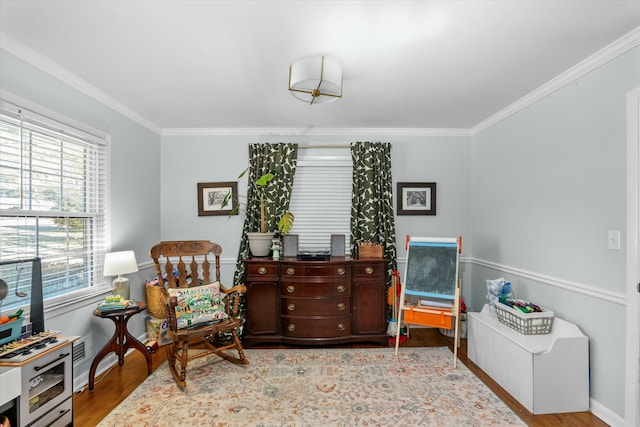 living area featuring ornamental molding and light hardwood / wood-style floors