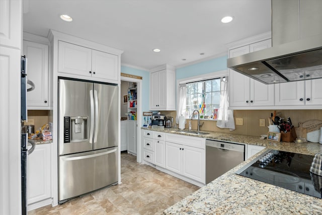 kitchen with sink, appliances with stainless steel finishes, white cabinetry, extractor fan, and light stone countertops