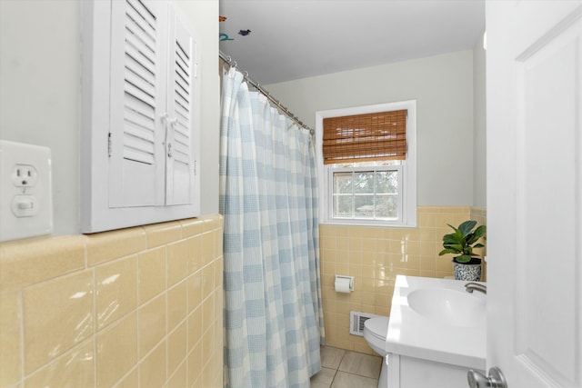 bathroom featuring tile walls, a shower with shower curtain, vanity, tile patterned floors, and toilet