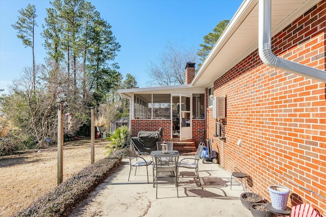 view of patio featuring a sunroom