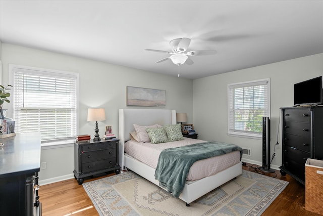 bedroom with ceiling fan and light hardwood / wood-style floors