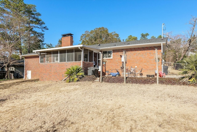 rear view of property with a sunroom