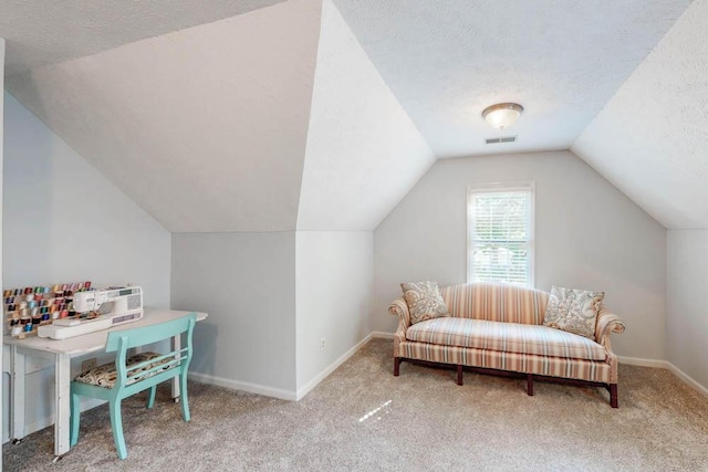 interior space with visible vents, carpet floors, lofted ceiling, baseboards, and a textured ceiling