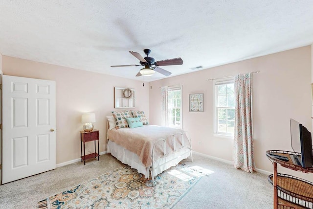 bedroom with baseboards, ceiling fan, carpet flooring, and visible vents