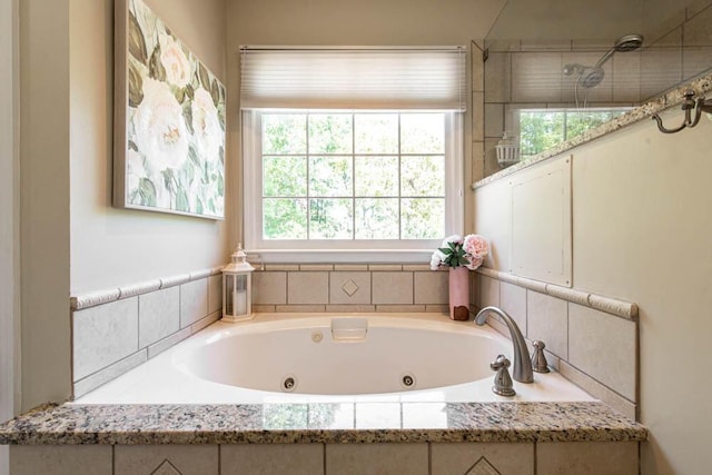 bathroom featuring a whirlpool tub, walk in shower, and a wealth of natural light