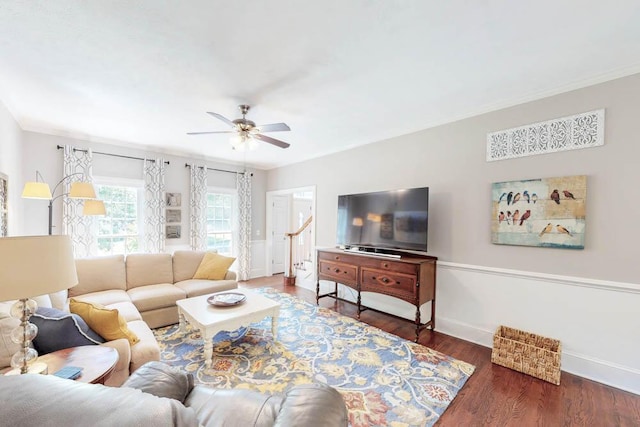 living room with crown molding, baseboards, a ceiling fan, and wood finished floors