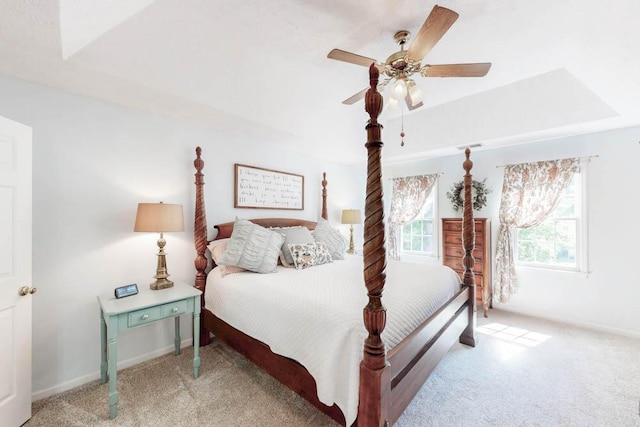 carpeted bedroom with baseboards and a ceiling fan