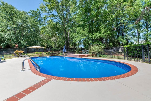 view of swimming pool featuring a fenced in pool, a patio area, and fence