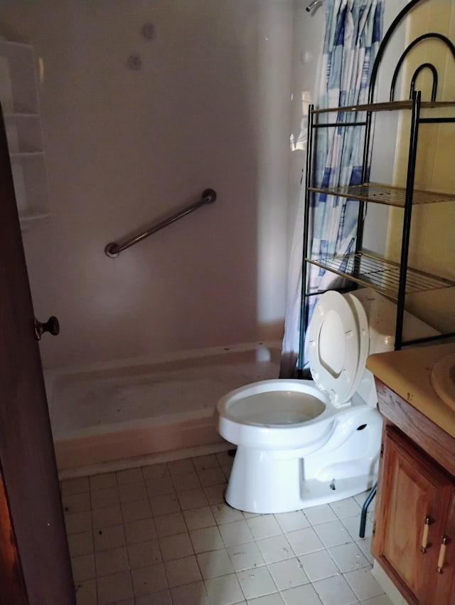 bathroom with toilet, tile patterned flooring, and vanity