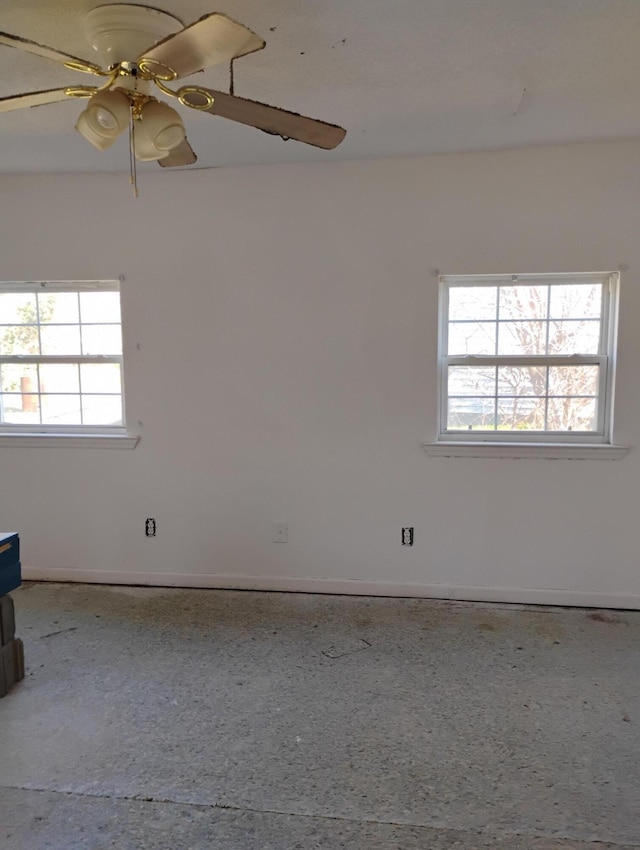 unfurnished room with ceiling fan and a healthy amount of sunlight