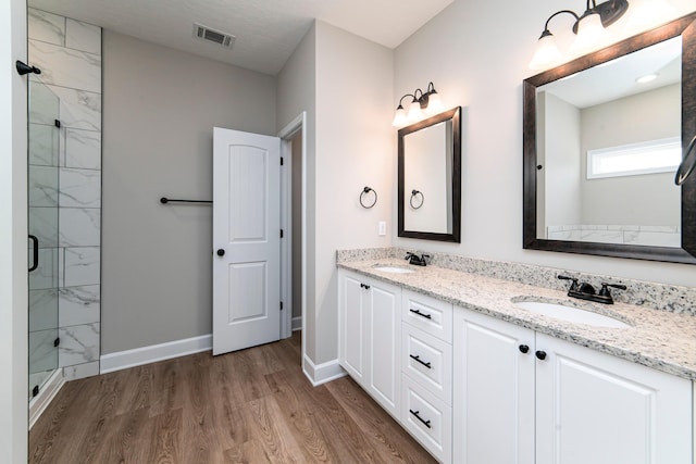 645 Jet Pass, Beech Island, SC 29842 - bathroom featuring a shower stall, wood finished floors, double vanity, and baseboards