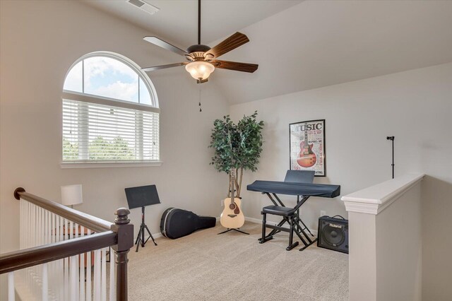 office area with ceiling fan, light carpet, and vaulted ceiling