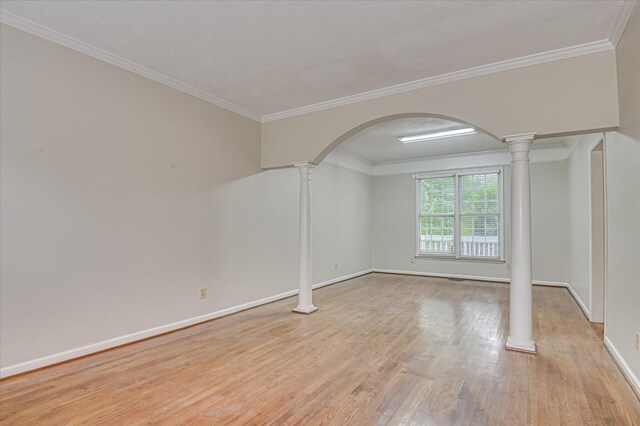 3696 El Cordero Ranch Springs Rd, Augusta, GA 30907 - spare room featuring decorative columns, light wood-type flooring, arched walkways, baseboards, and crown molding