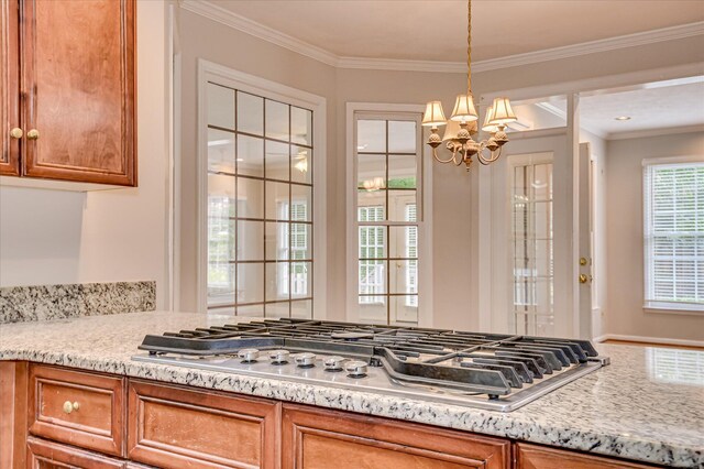 3696 El Cordero Ranch Springs Rd, Augusta, GA 30907 - kitchen featuring stainless steel gas cooktop, a chandelier, brown cabinetry, pendant lighting, and crown molding
