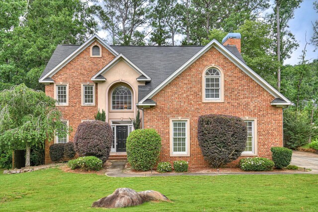 3696 El Cordero Ranch Springs Rd, Augusta, GA 30907 - traditional-style home with a chimney, a front yard, brick siding, and a shingled roof