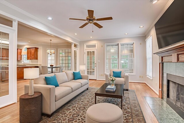 3696 El Cordero Ranch Springs Rd, Augusta, GA 30907 - living area featuring light wood-style flooring, healthy amount of natural light, a fireplace, ornamental molding, and recessed lighting