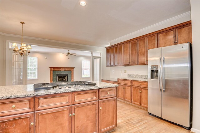 3696 El Cordero Ranch Springs Rd, Augusta, GA 30907 - kitchen featuring appliances with stainless steel finishes, ornamental molding, a ceiling fan, light wood-type flooring, and a tiled fireplace